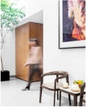 sollis waiting room area with chairs, plant, artwork, and moving person - smaller version